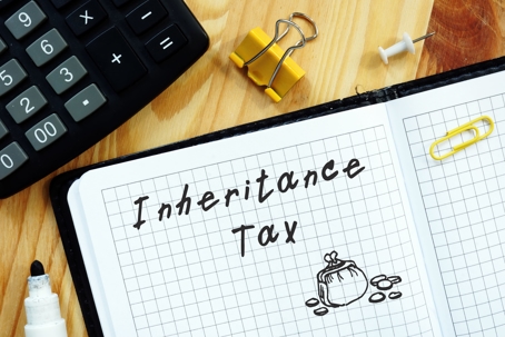 Inheritance Tax written our with office supplies and calculator